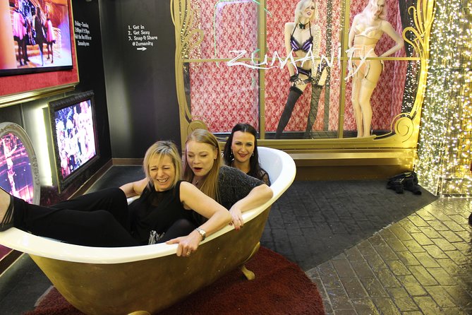 2-Hour Vegas Strip Walking Tour with Photos,Champagne & Vintage Vegas Goody Bags - Cosmopolitan: the red shoe, the chandelier bar, and dog statue poses